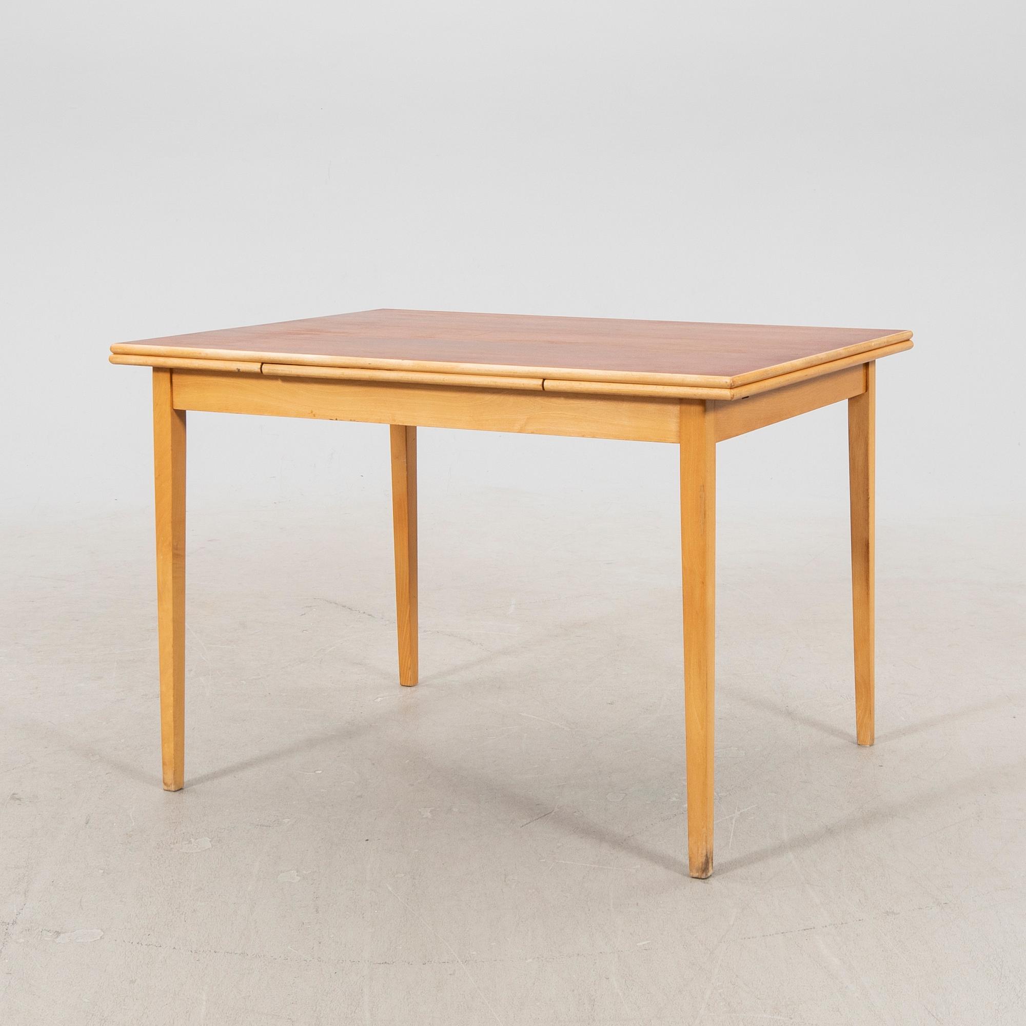 A 1960s teak and beech dining table.