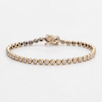 An 18K gold tennis bracelet, with diamonds totalling approximately 0.78 ct.