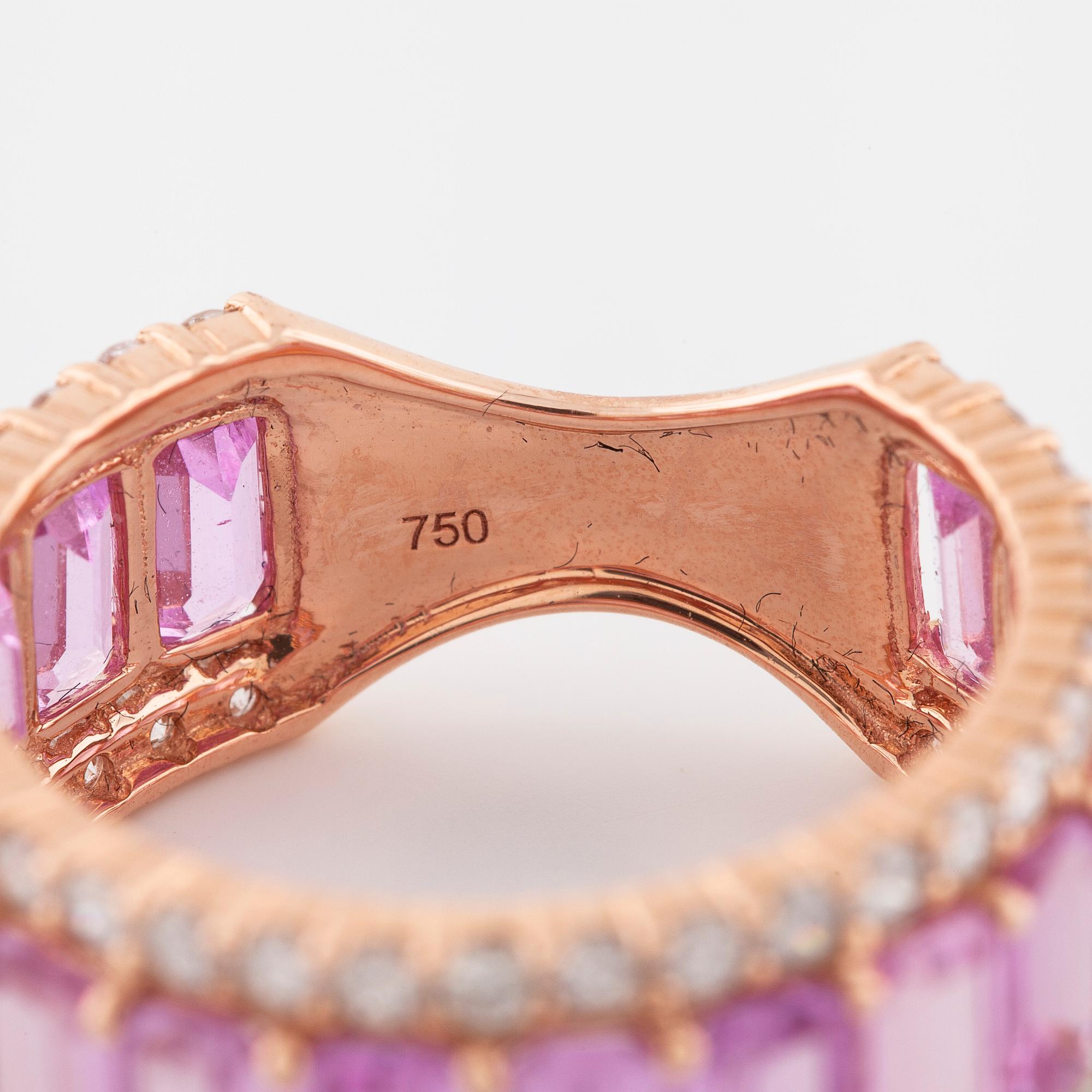 An emerald cut pink sapphire and brilliant cut diamond ring.