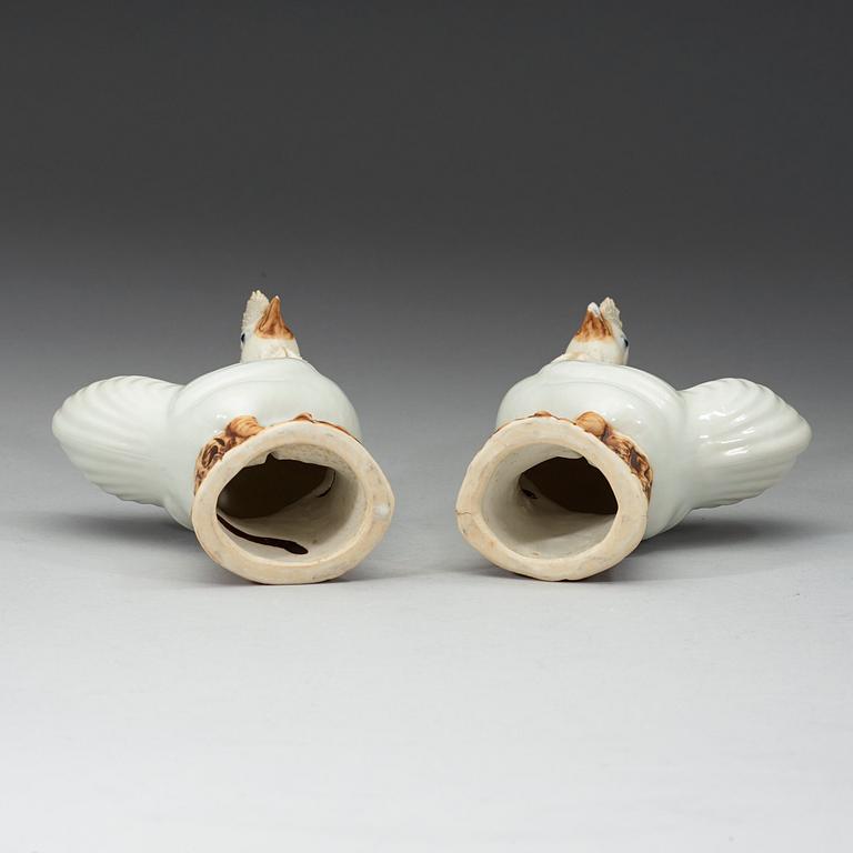 A pair of white and brown glazed figures of roosters, late Qing dynasty,