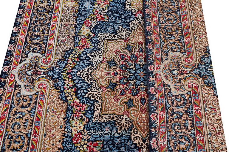 A Kerman Laver carpet, c. 252 x 150 cm.