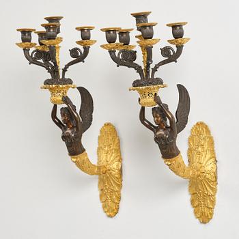 A pair of French Empire five-branch gilt and patinated bronze appliques, first part 19th century.