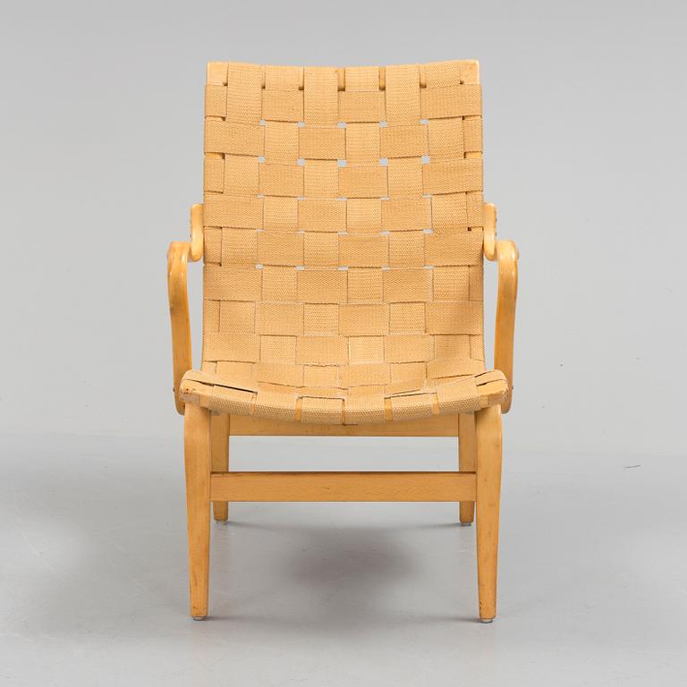 an "Eva" armchair by BRUNO MATHSSON 1963.