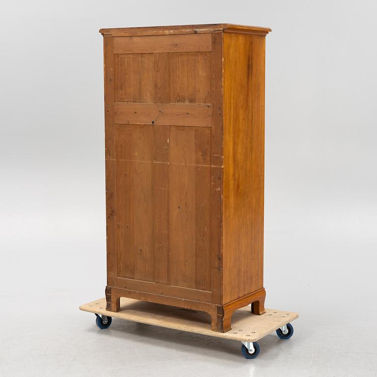 A walnut veneered tall boy dresser, early 20th century.