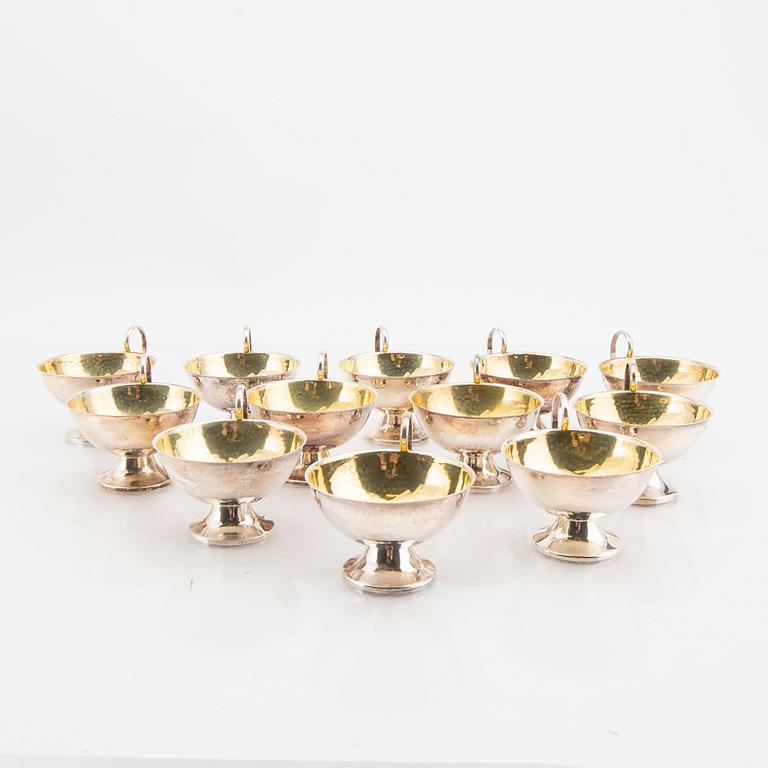 A Swedish set of 12 silver cups mark of K&E Carlson Gothenburg 1948, weight 382 grams.