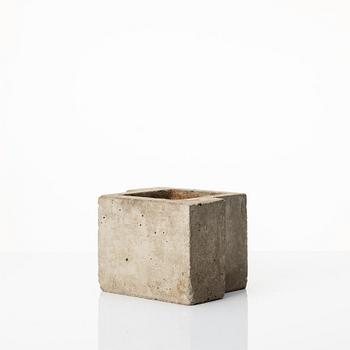 Stina Lindholm, a contemporary concrete planter 'Spira', a concrete flower pot and a wall clock.