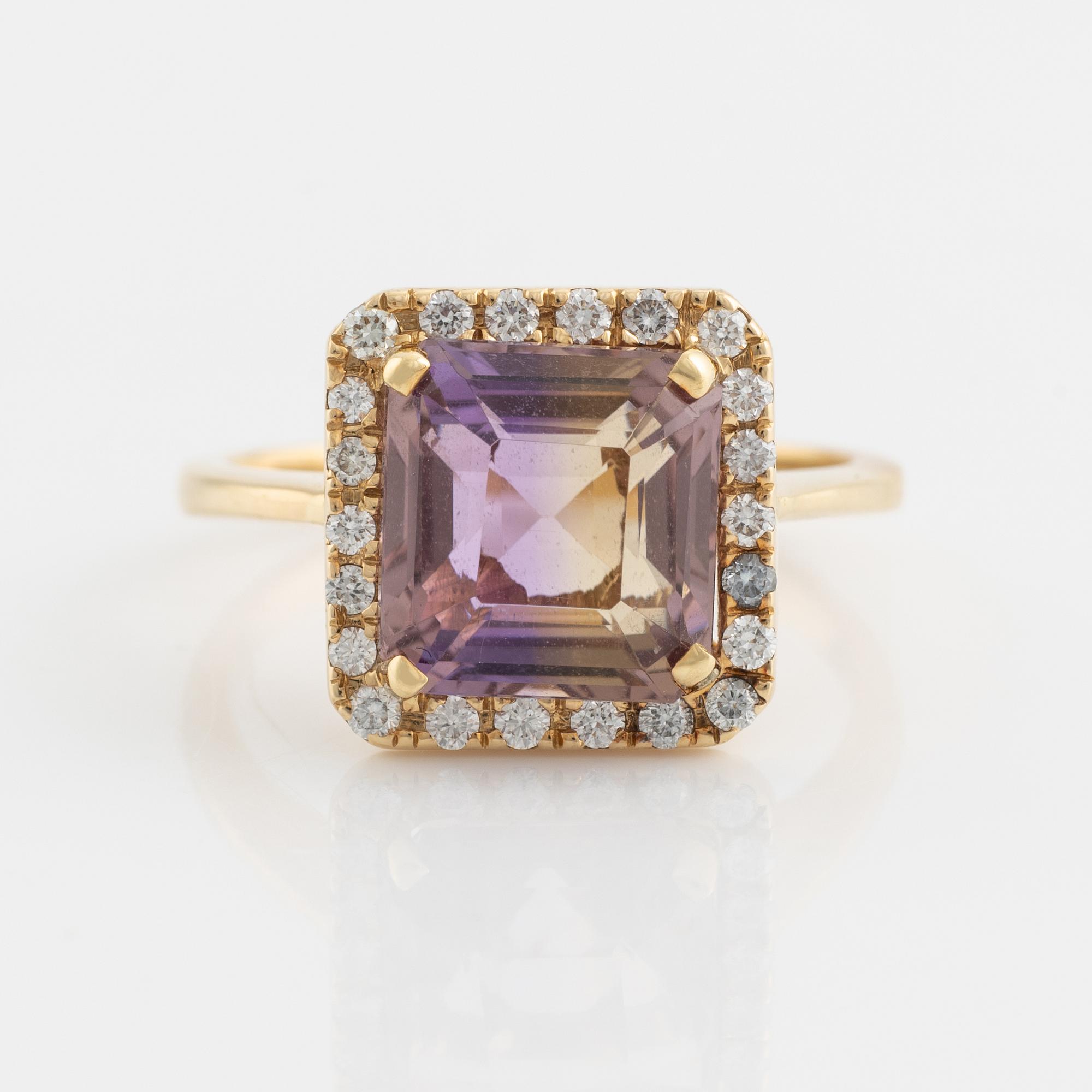 An 18K gold and ametrine ring set with round brilliant-cut diamonds.