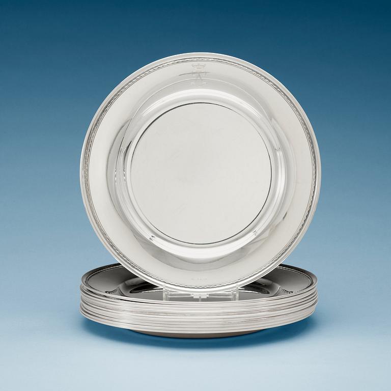 A set of 12 silver dinner plates by Guldsmedsaktiebolaget, Stockholm 1952-55.