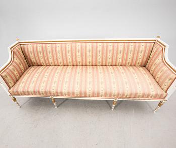 A painted and guilded late gustavian sofa from the 19th century.