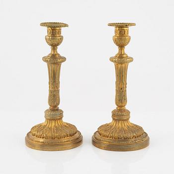 A pair of bronze candle sticks, 20th Century.