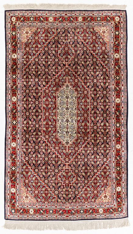 An oriental silk rug, c. 177 x 104 cm.