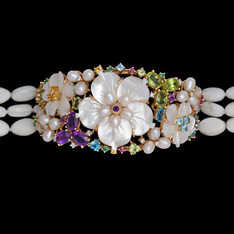 A mother of pearl and precious stone bracelet.