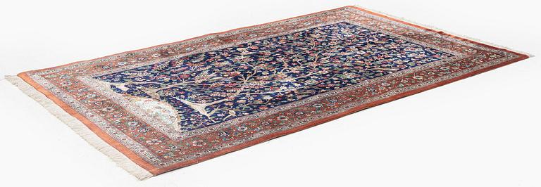 A signed pictoral silk Qum rug, c. 203 x 127 cm.