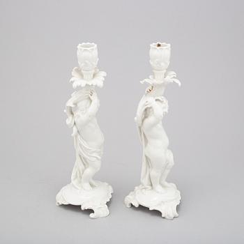 A German white glazed figure group and a pair of Berlin candle sticks, 20th Century.