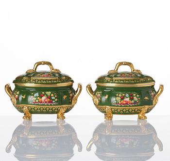 A pair of armorial butter tureens with covers and stands and two fruit dishes, Derby, England, circa 1830.