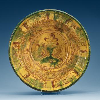 806. A large green and yellow glazed dish, 18th Century.
