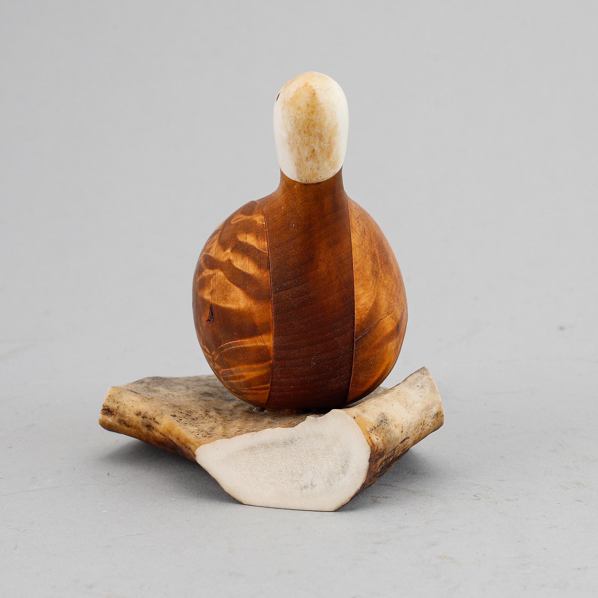 Lars Levi Sunna, a Sami reindeer horn and birch figurine of a grouse, signed LL Sunna.