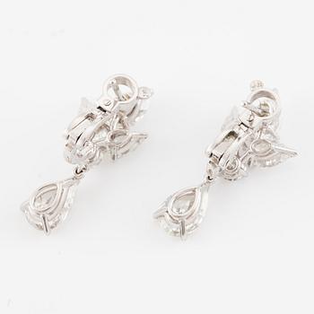 Cartier a pair of earrings platinum set with drop-shaped and round brilliant-cut diamonds.