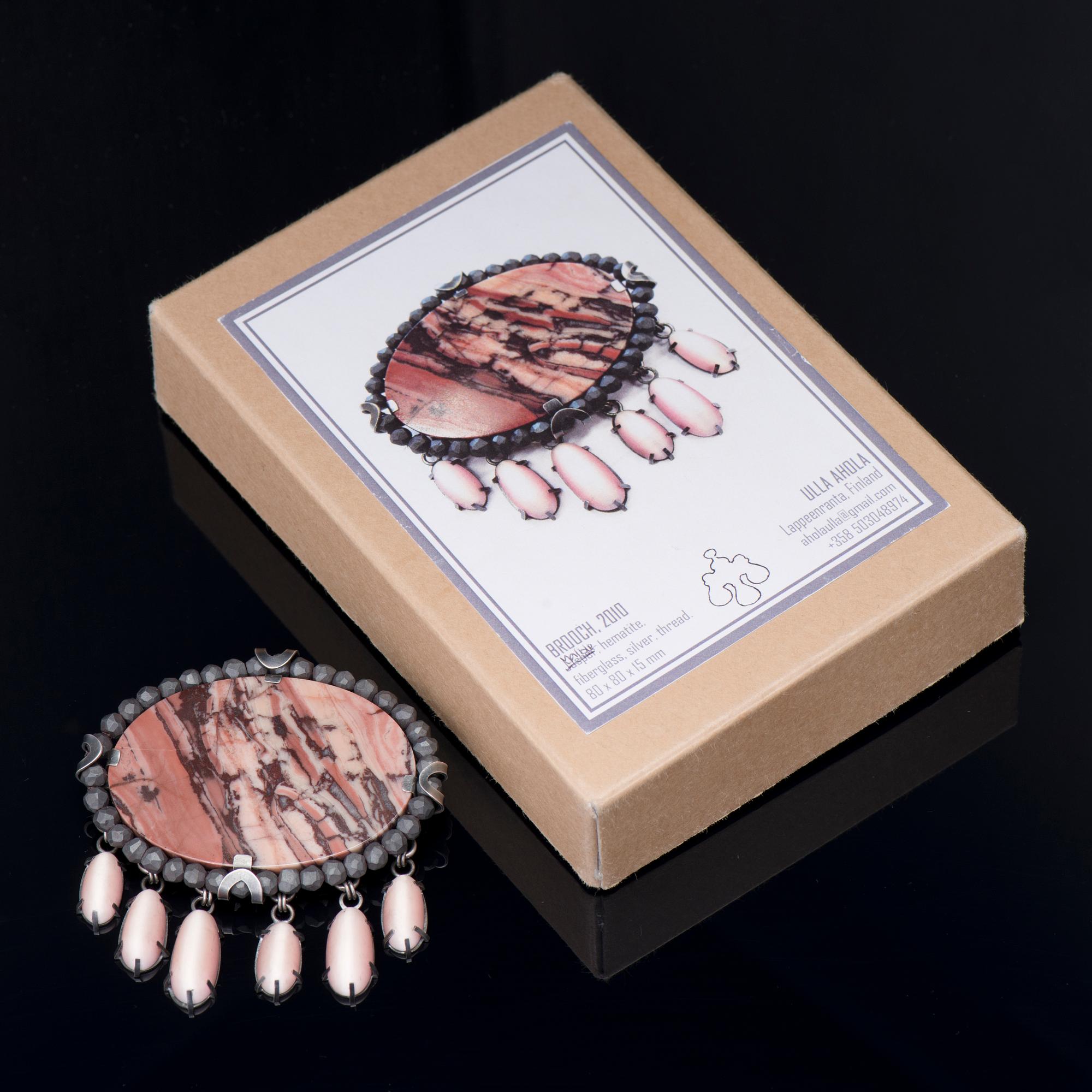 A ULLA AHOLA BROOCH, silver, marble, hematite, hand cut glass, 2010.