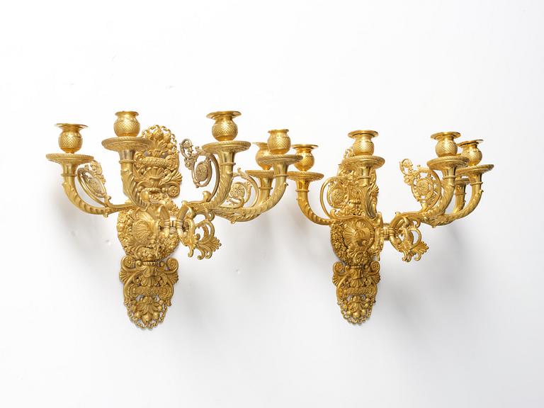 A pair of French Empire ormolu five-branch wall-lights, Paris, early 19th century.