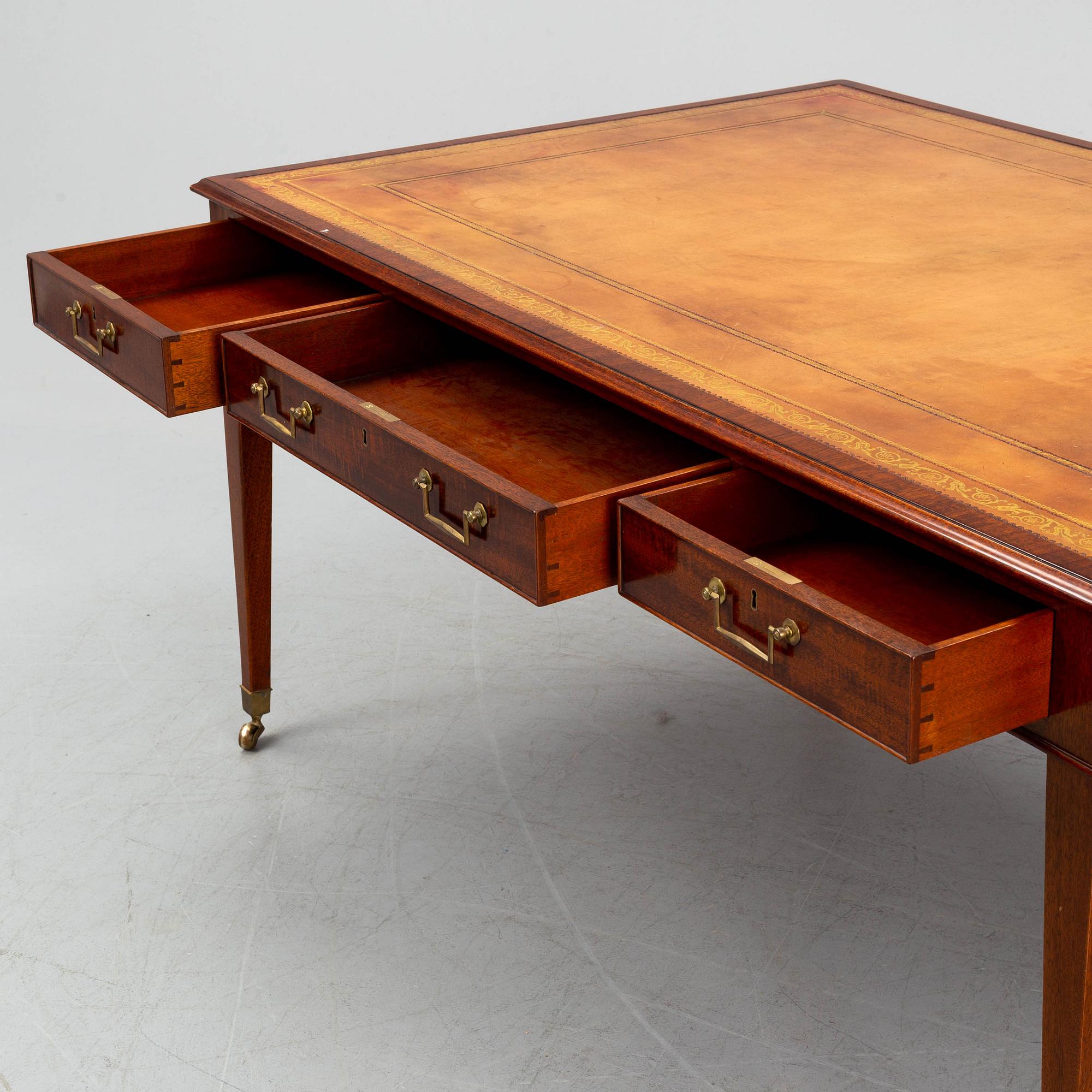 A contemporary mahogany and leather partners desk in the George III style.