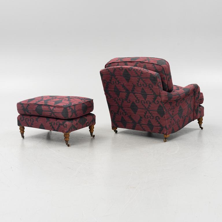 A Howard style easy chair with av footstool, 21st Century.