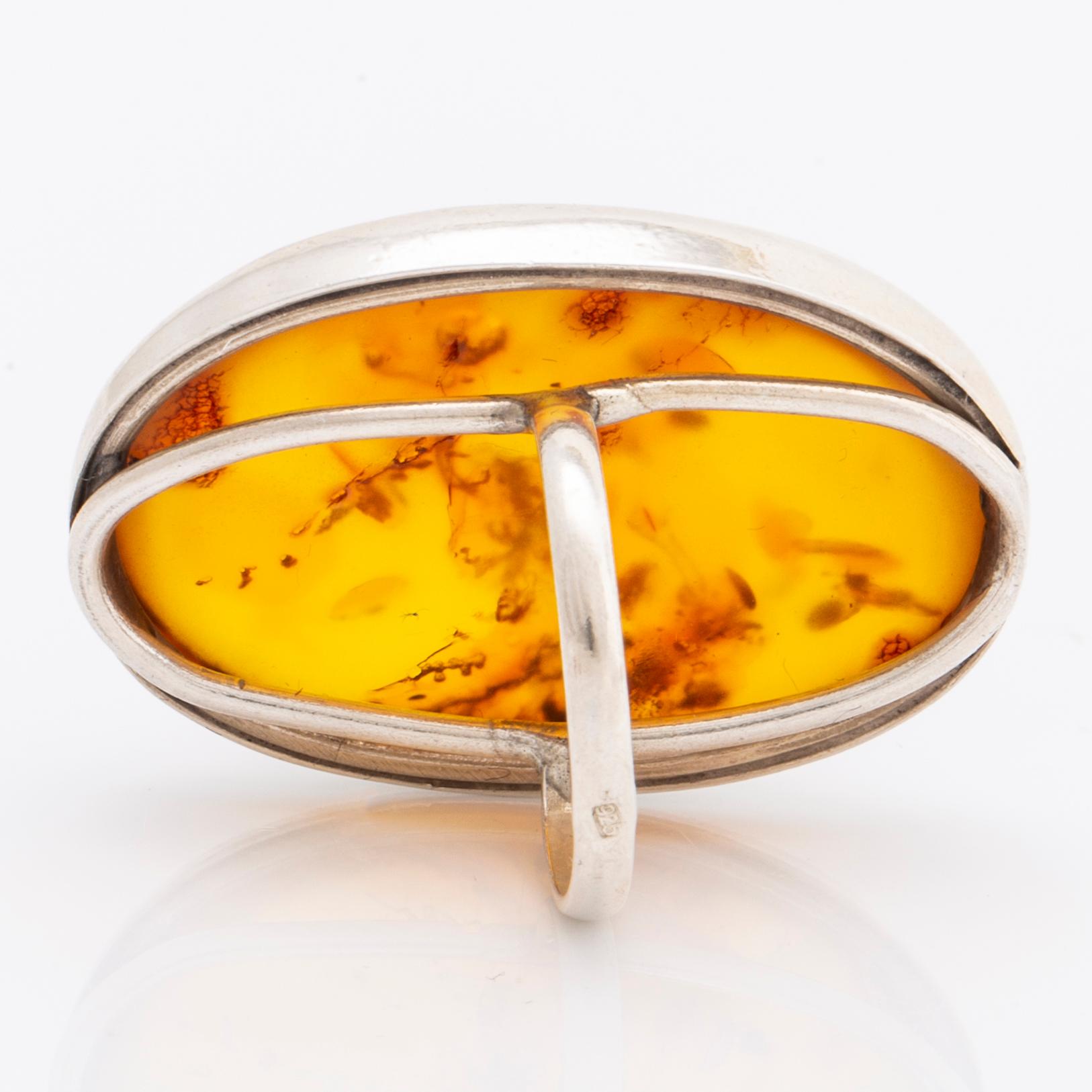 Amber set in silver, pendant, ring and earrings.