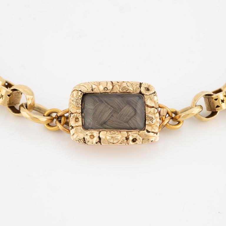 Necklace with a hair compartment, gilded silver.