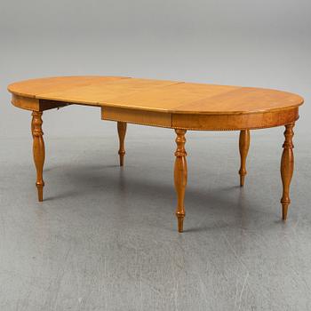 A mid 19th century birch dining table.