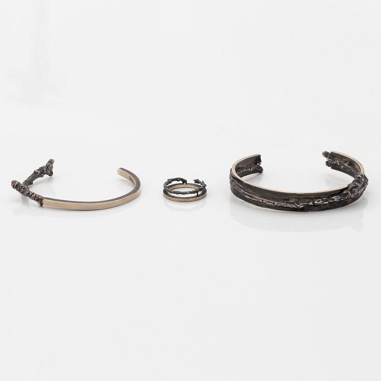 Two Copula silver bracelets and a ring.