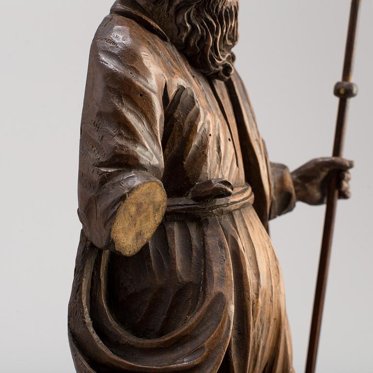 A 17TH CENTURY CARVED WOOD SCULPTURE OF A SAINT.