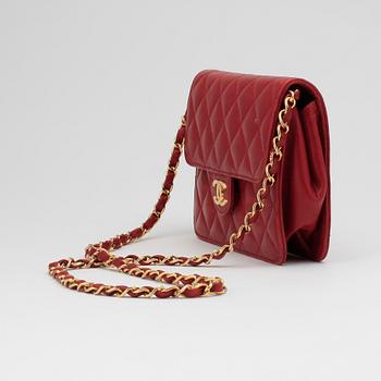 CHANEL, a red leather shoulder bag.
