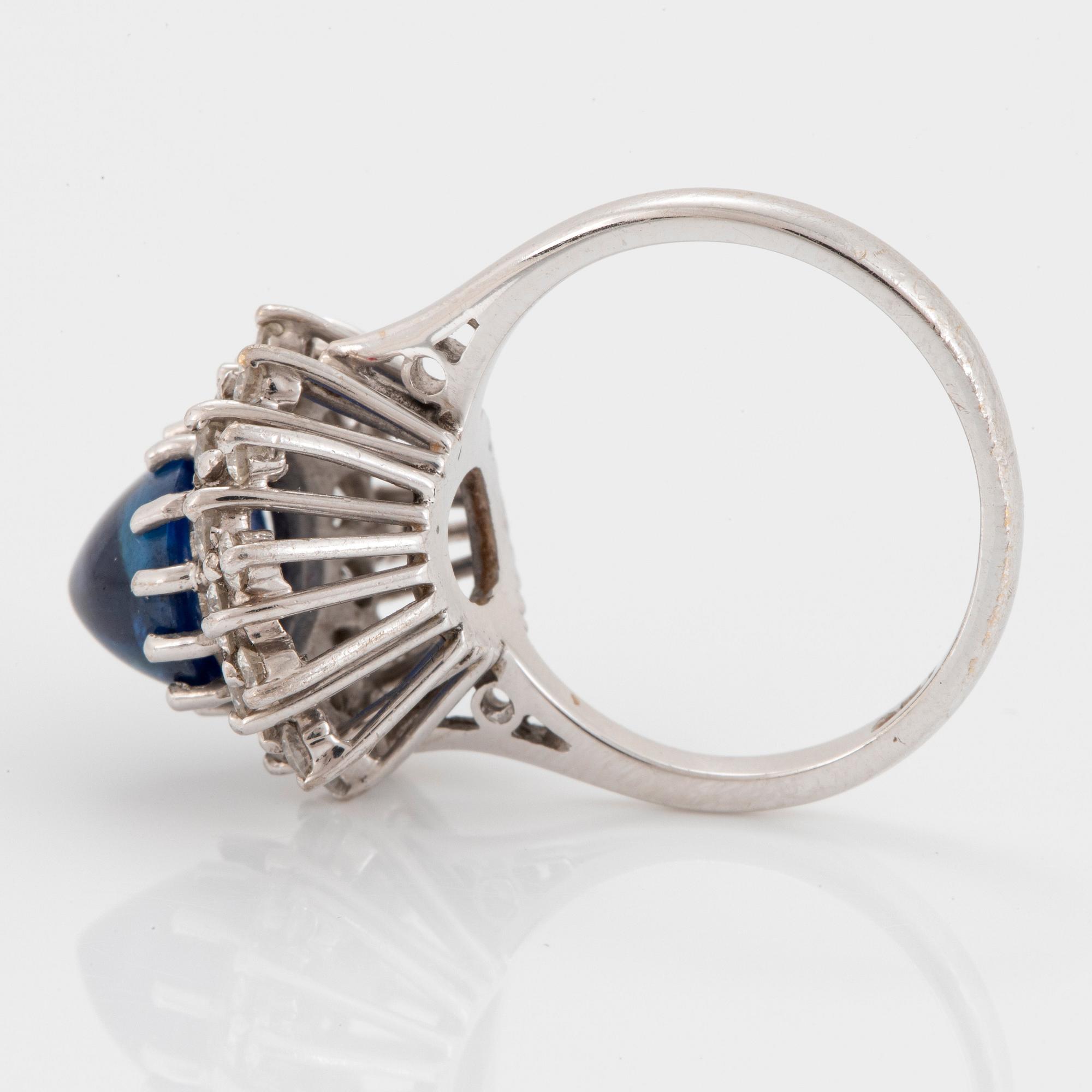 Ring 18K vitguld med en cabochonslipad safir ca 4.00 ct samt runda briljantslipade diamanter.