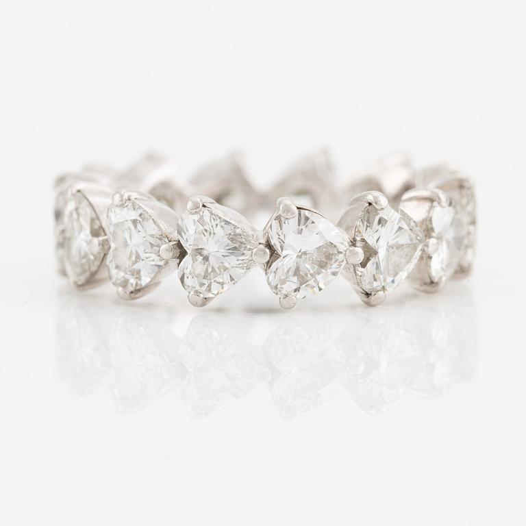 A Graff platinum eternity band set with heart shaped diamonds.