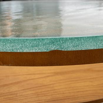 A Swedish Modern coffee table with a glass top. 1940's.
