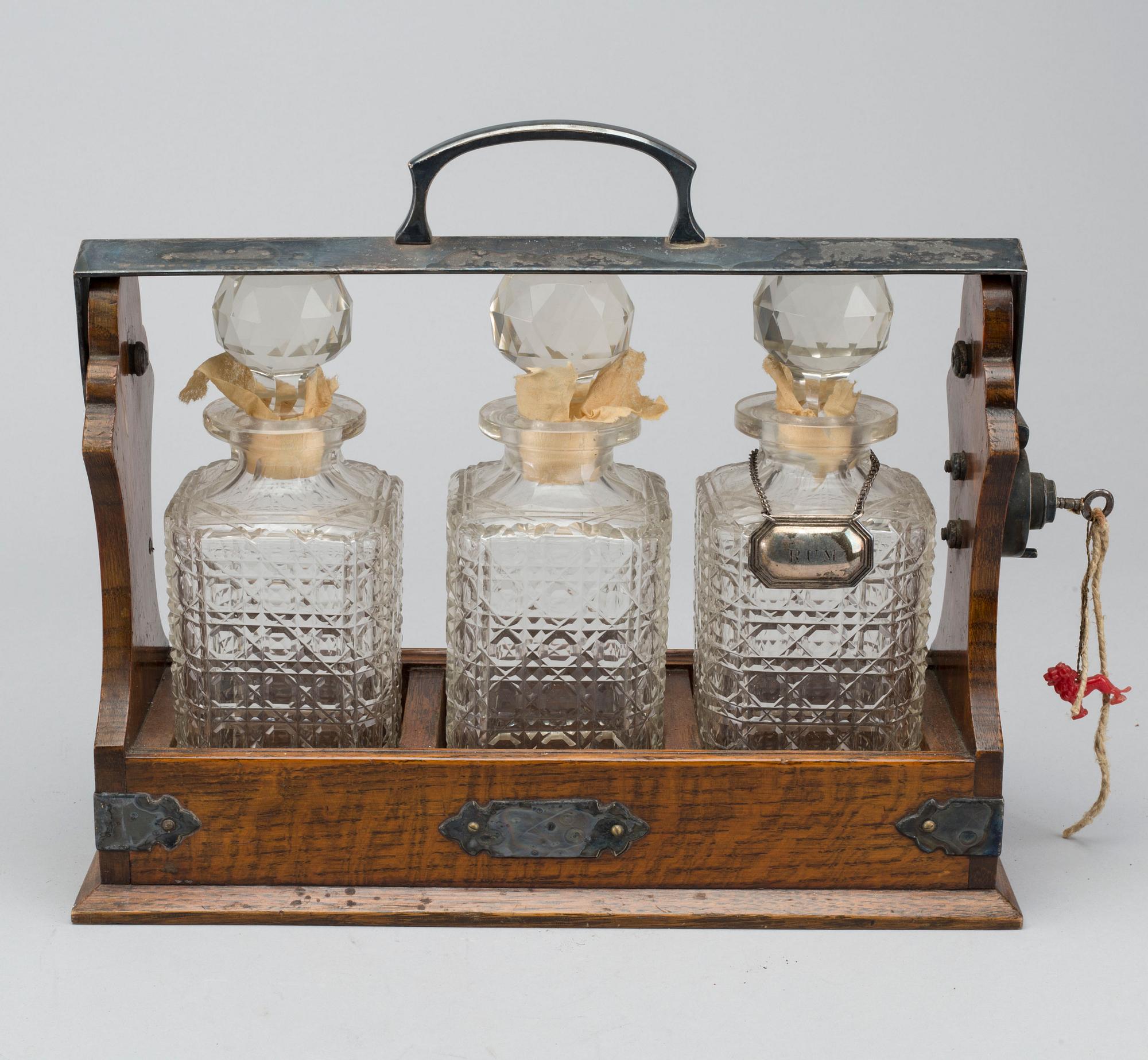 A EARLY 20TH CENTURY TANTALUS 'THE TANTALUS'.