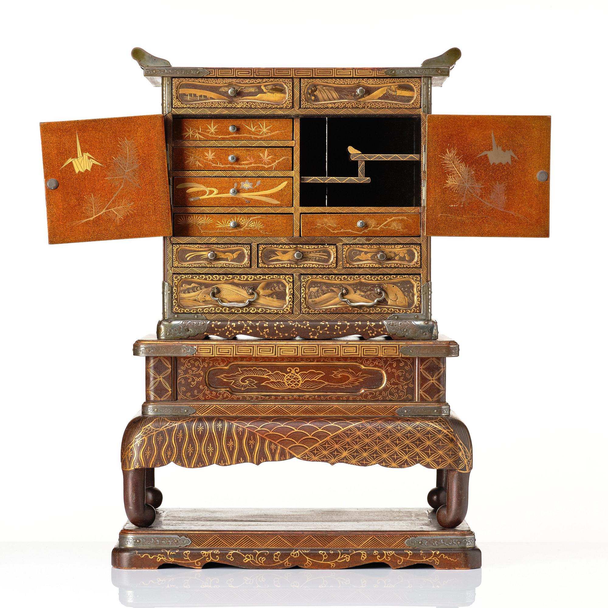 A Japanese lacquer cabinet on a stand, Meiji period (1868-1912).