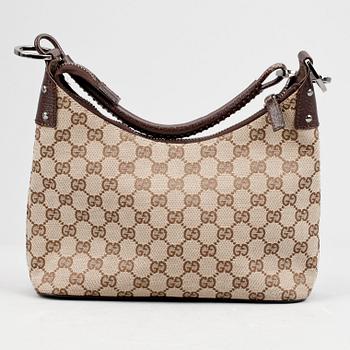 GUCCI, a beige monogram canvas shoulderhandbag.