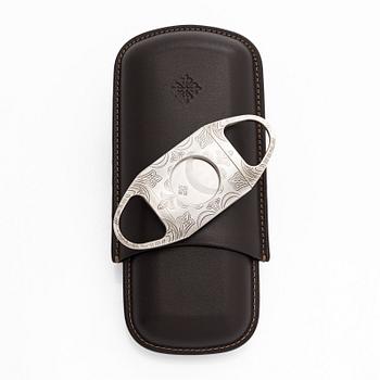 Patek Philippe, a cigar cutter and leather case.