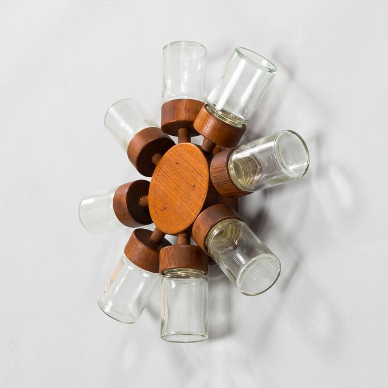 A Danish 1960s wall mounted spice rack in teak and glass from Digsmed.