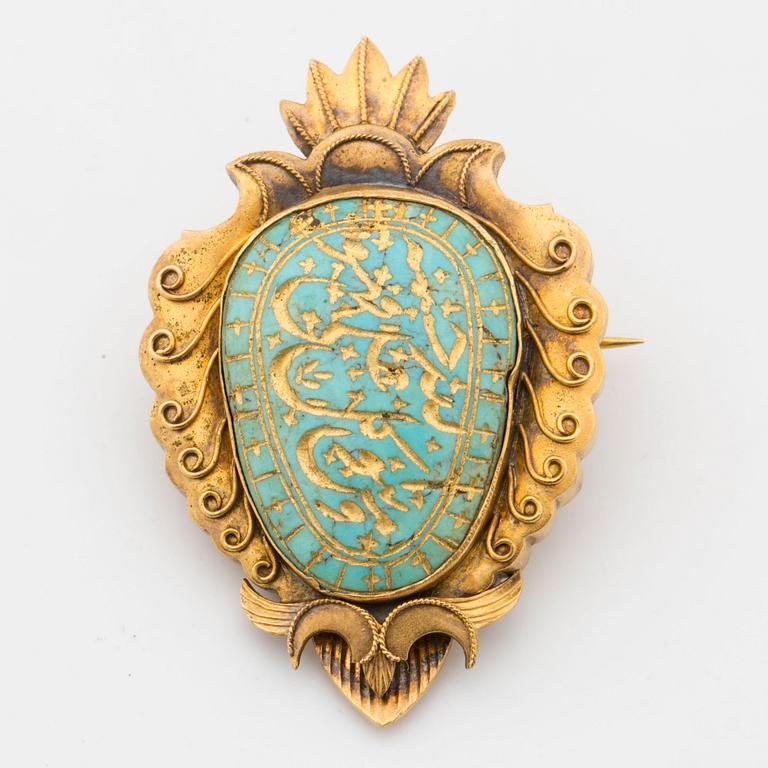 Brooch with carved turquiose and place for photo.