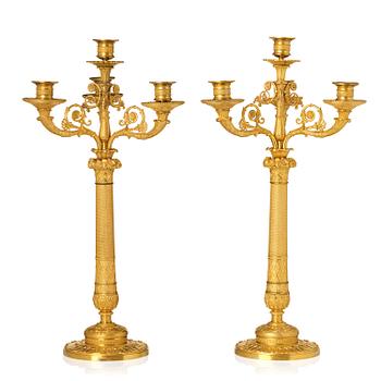 79. A pair of French Empire four-light gilt bronze candelabra, early 19th century.