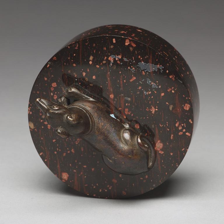 A bronze figure of a reclining dog, 17/18th Century.