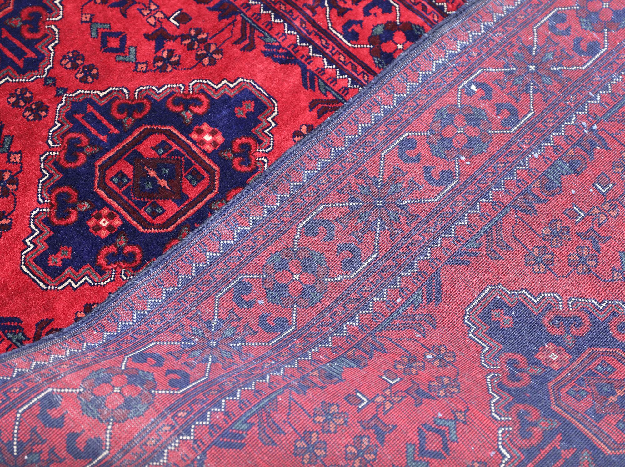 An Afghan runner, approximately 283 x 87 cm.