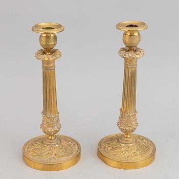 A circa 1900 empire style brass candlesticks.
