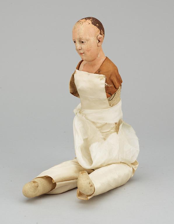 A 19th century wooden doll.