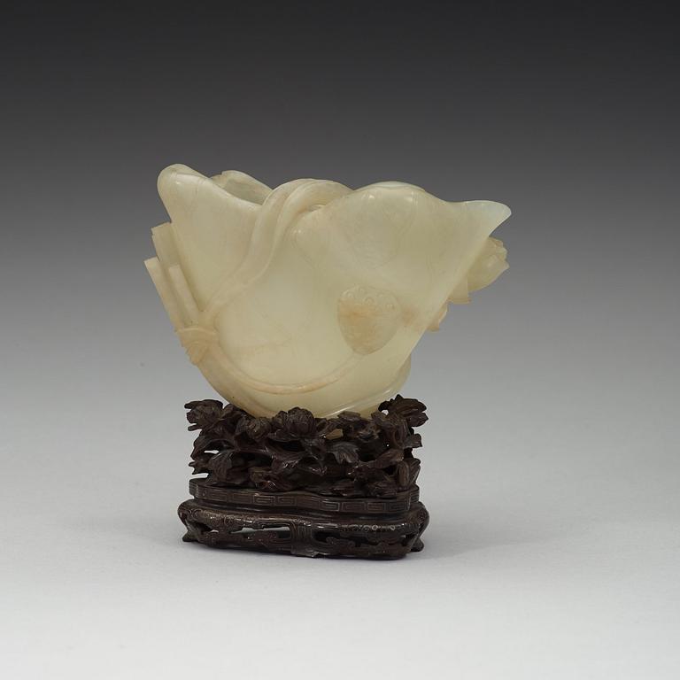 A nephrite brush washer, on a hardwood stand with silver inlay, Qing dynasty (1644-1912).