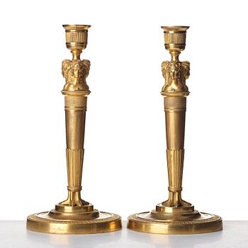 A pair of French Empire early 19th century gilt bronze candlesticks.