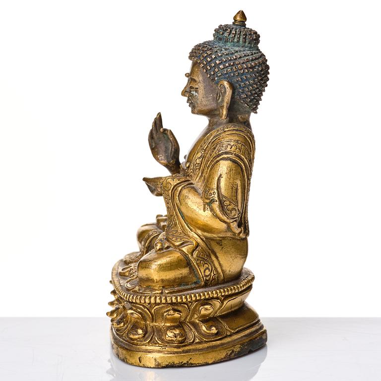 A partly gilt Tibeto-Chinese figure of Maitreya Buddha, 17th century.