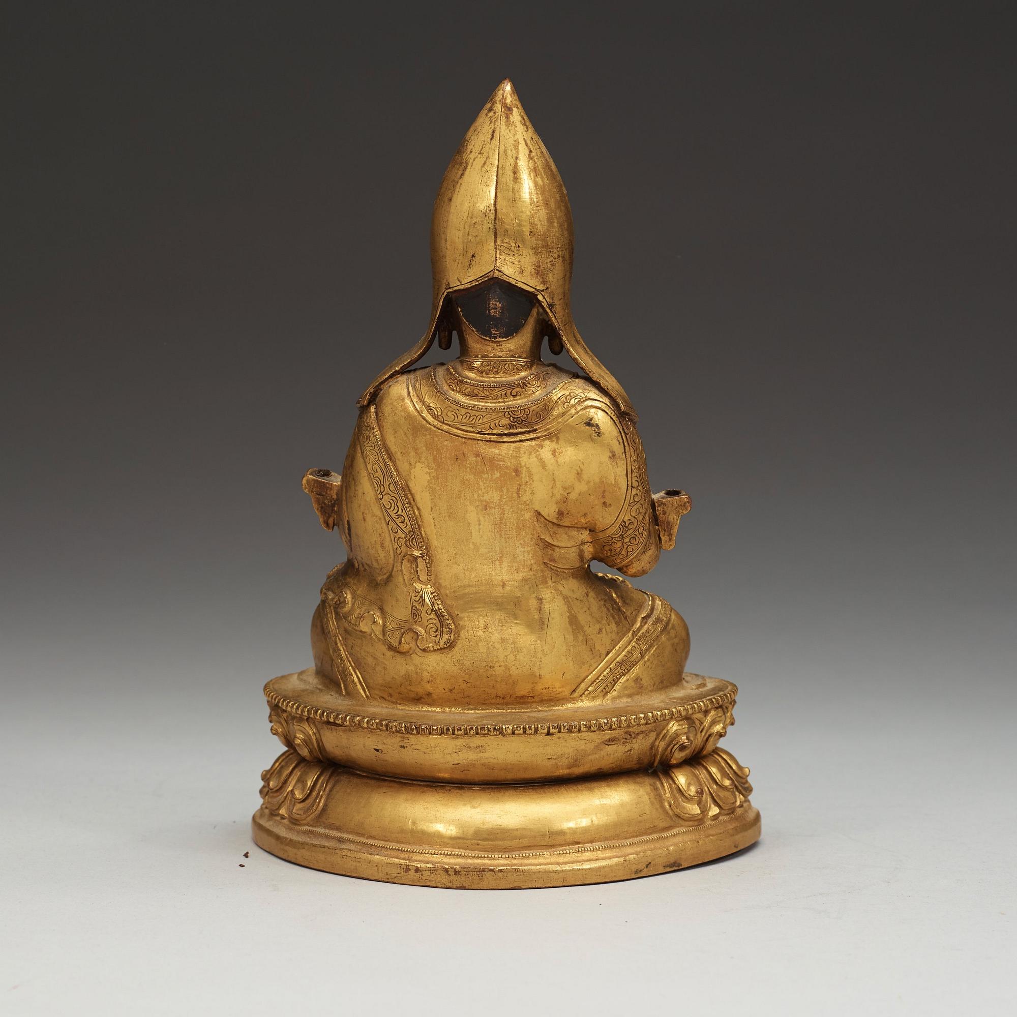 A Sino-Tibetan gilt copper alloy repoussé figure of Tsong Khapa, 18/19th Century.